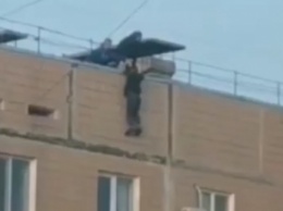 Девочка-подросток в Запорожье повисла на крыше девятого этажа (видео)